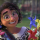 A character from Disney's Colombian animated musical Encanto. She's wearing glasses, smiling awkwardly and holding paper flowers and jars.